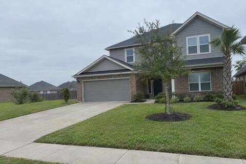 Two-story brick and fiber-cement house with a new architectural shingle roof and a palm in the front yard